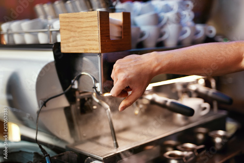 Preparing Drink In Coffee Machine By Barista At Cafe