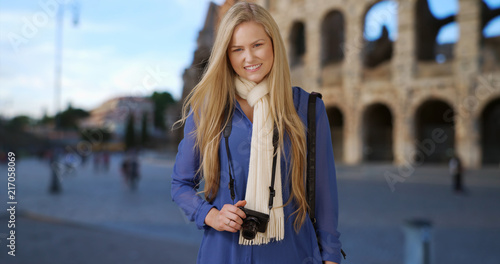 Smiling blonde female traveling in Rome enjoys her vacation © rocketclips