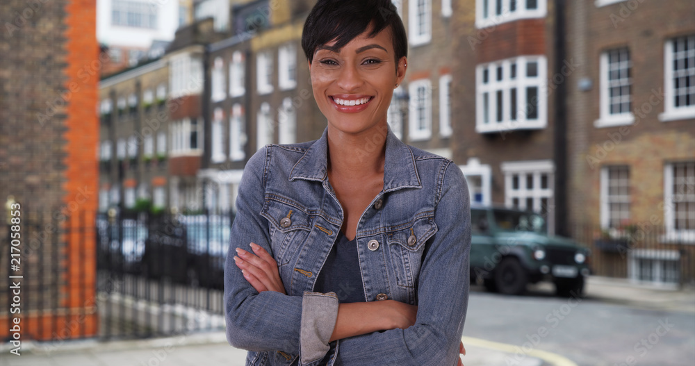 Good-looking African-American female in London looks at camera happily 
