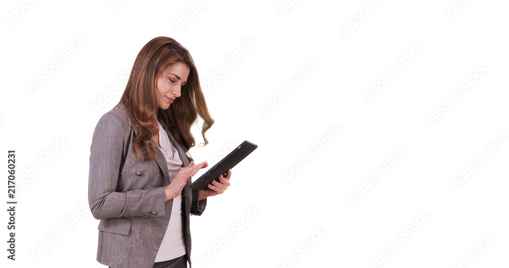Portrait of good-looking white female using tablet device on white background Portrait of good-looking white female using tablet device on white background