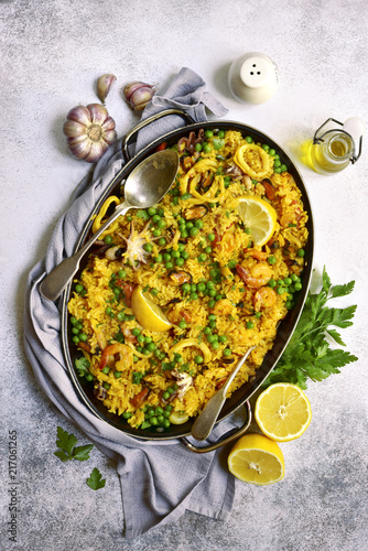 Classic valencian paella from rice with seafood and green pea - traditional dish of spanish cuisine.Top view.