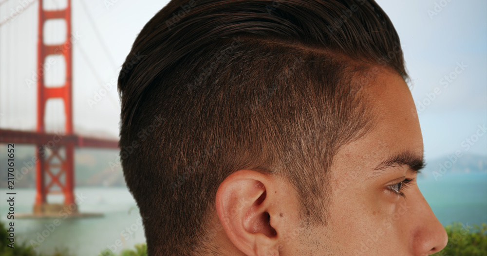 Close up of Latino male with cool undercut standing near Golden Gate Bridge Close up of Latino male with cool undercut standing near Golden Gate Bridge