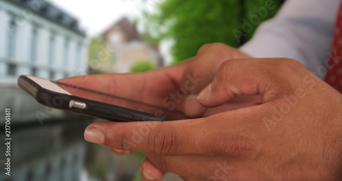 Close up of Latino businessman text messaging on smart phone © rocketclips