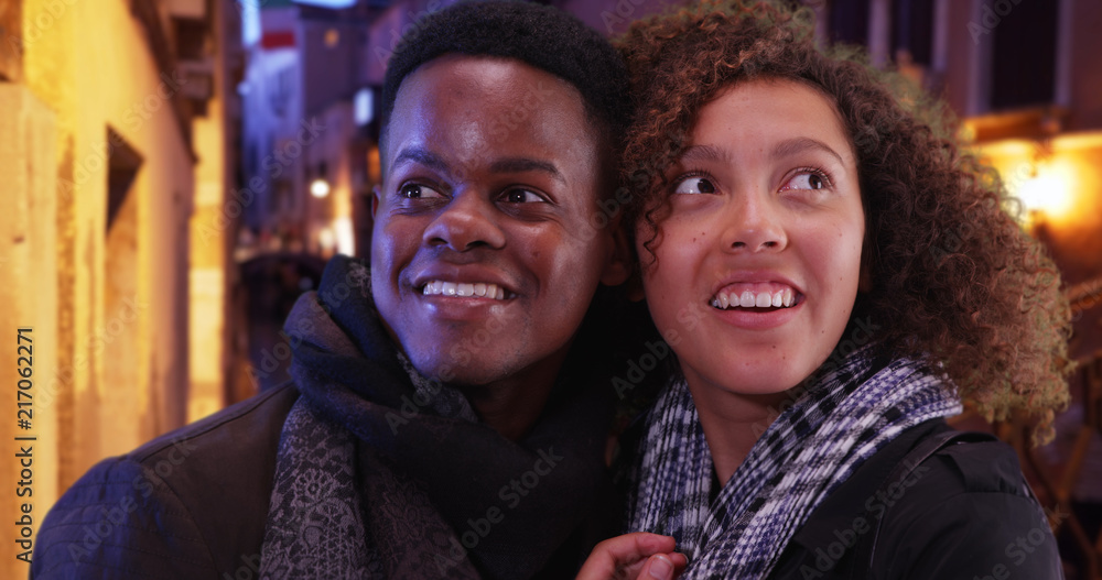 Happy black couple exploring Venice at night looking around and smiling Happy black couple exploring Venice at night looking around and smiling