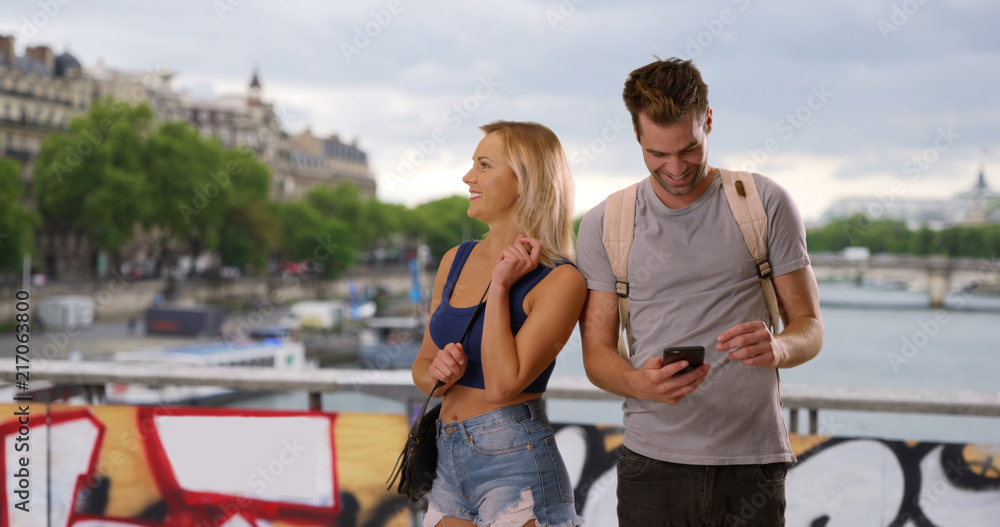 Lost young couple use smartphone for directions in Paris Lost young couple use smartphone for directions in Paris