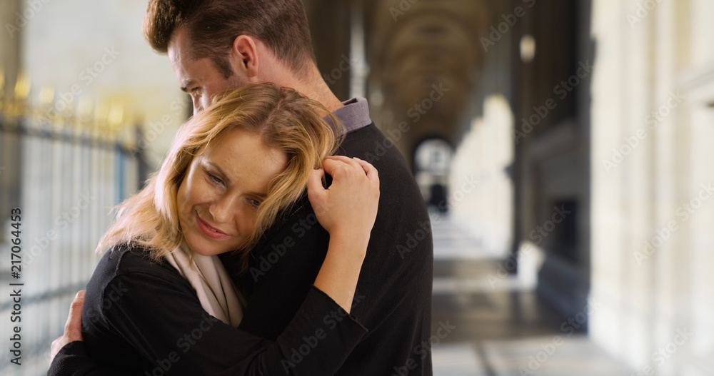 Pretty Caucasian woman hugging her boyfriend