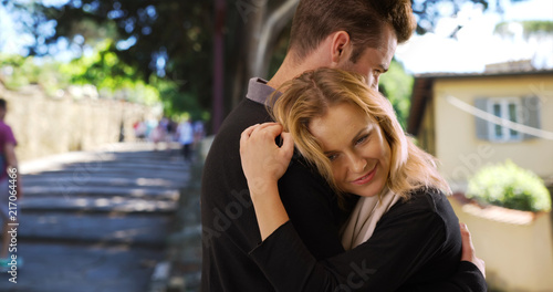 Pretty Caucasian woman hugging her boyfriend in Europe © rocketclips