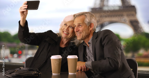 Photography Happy mature couple taking a selfie in Paris