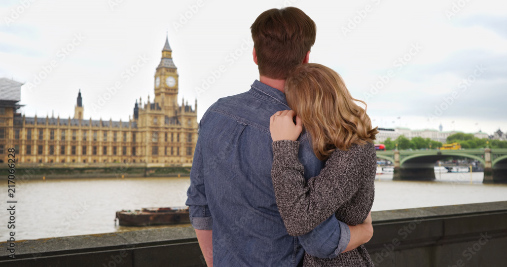 Rear view of loving young couple looking out at the River Thames London