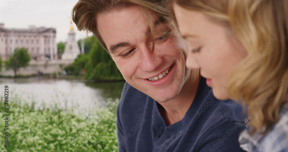 Close up of cheerful couple relax at the park talking to each other