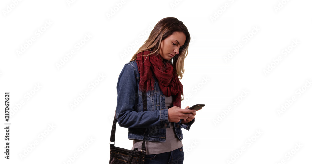 Pretty Caucasian woman in her 20s using mobile phone on white background Pretty Caucasian woman in her 20s using mobile phone on white background