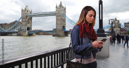 London woman texting with mobile phone outdoors