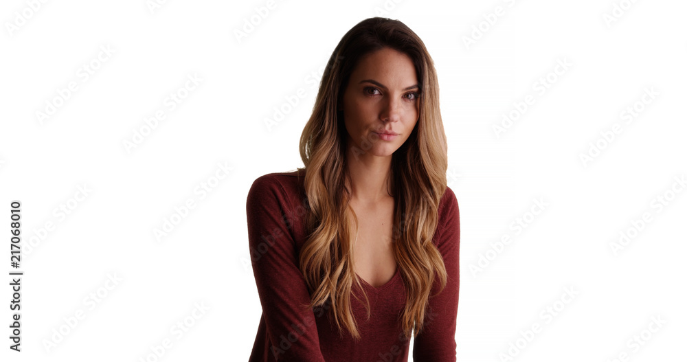 Pretty Caucasian woman turns to look at camera in studio with copyspace Pretty Caucasian woman turns to look at camera in studio with copyspace