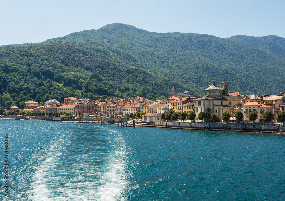 the boat starts again from Cannobio, colorful village, leaving a long trail on Lake Maggiore, Italy