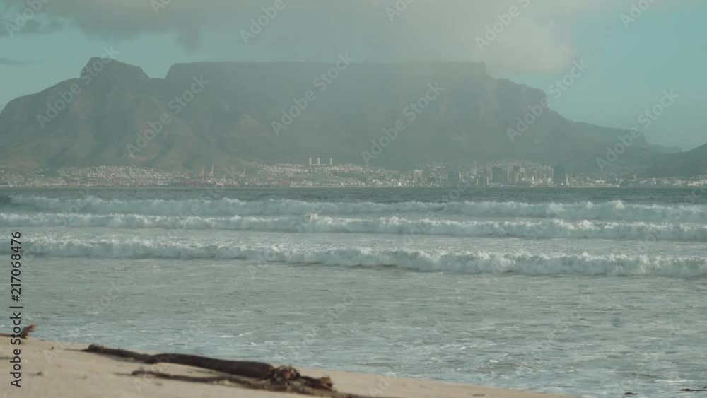 View of Table Mountain and Cape Town, South Africa with sand and sea in the foreground. View of Table Mountain and Cape Town, South Africa with sand and sea in the foreground.