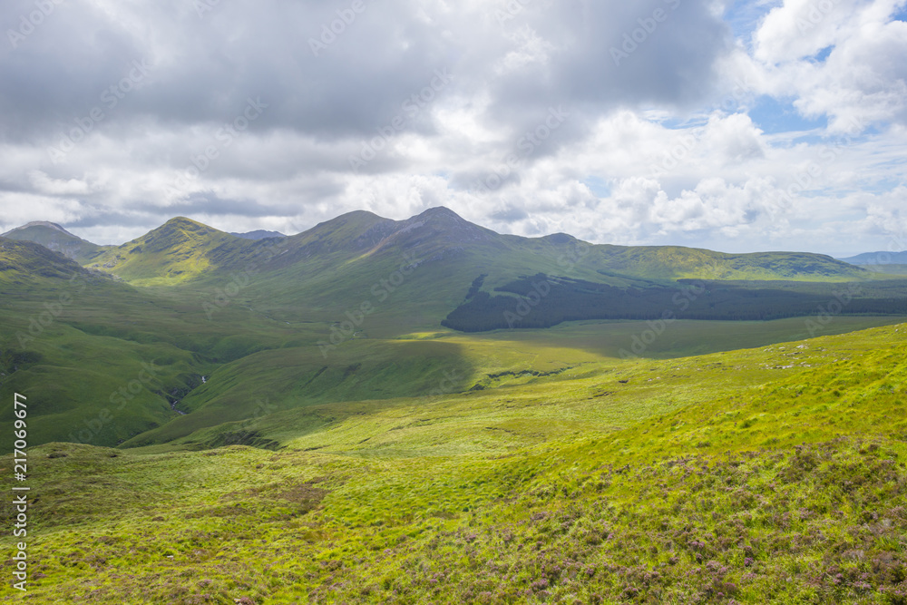 Panorama of mountains, marshy land and heathland of Connemara National Park in summer