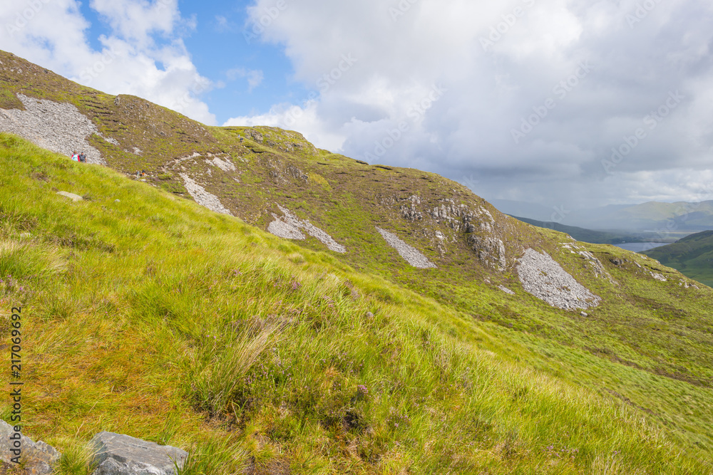 Panorama of mountains, marshy land and heathland of Connemara National Park in summer