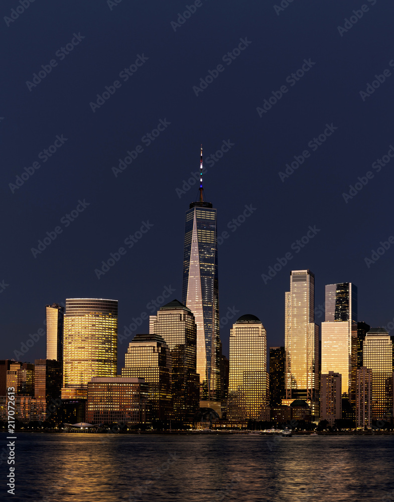 Fototapeta premium New York City / USA - JUL 19 2018: Lower Manhattan skyline at sunset view from Hudson riverside