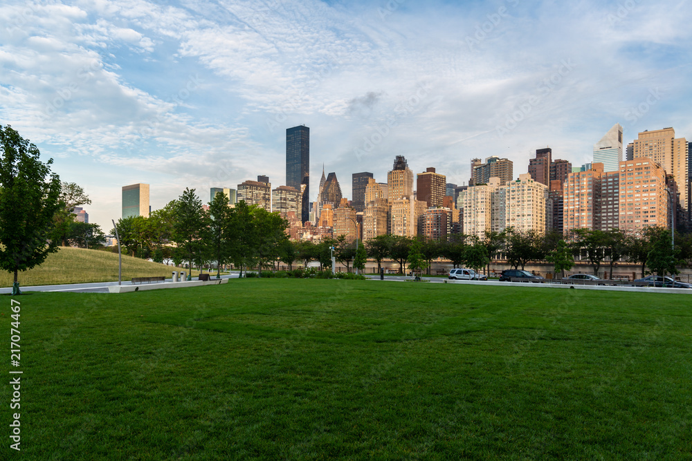 New York City / USA - JUL 31 2018: Midtown Manhattan buildings, skyscrapers and apartments view from Roosevelt Island at sunrise