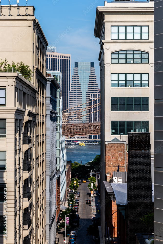 Brooklyn, NY / USA - JUL 31 2018: Buildings in Dumbo with Lower Manhattan skyscrapers in background view Brooklyn, NY / USA - JUL 31 2018: Buildings in Dumbo with Lower Manhattan skyscrapers in background view