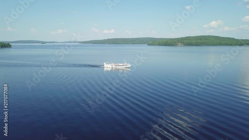 Bigboat is turning at big lake middle of beautiful Finland photo