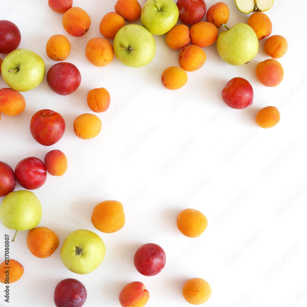 Plum, apples and apricots isolated on white background. Creative flat layout of fruit, top view.