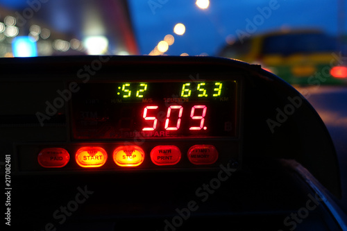 image of taxi meter and dashboard interior, view from backseats 