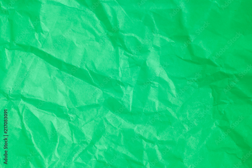 Fototapeta premium Green crumpled paper background.