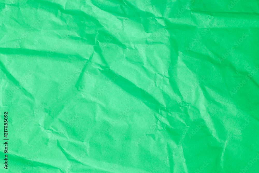 Fototapeta premium Green crumpled paper background.