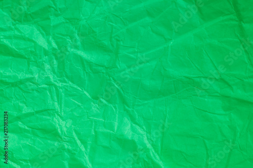 Green crumpled paper background.