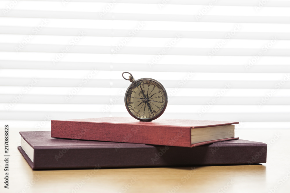 © dohee - vintage compass on the wood table at the office © dohee - vintage compass on the wood table at the office