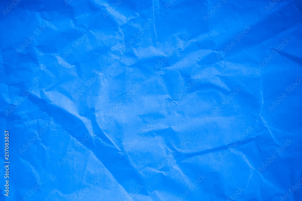 Obraz premium Crumpled blue paper background.