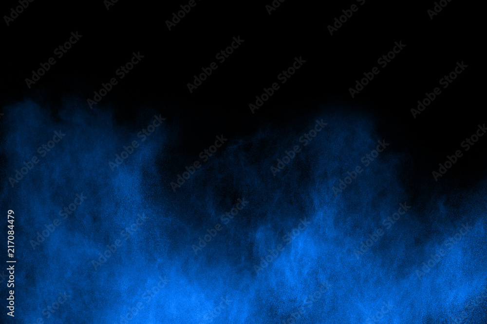 Blue powder explosion on black background. Colored cloud. Colorful dust explode. Paint Holi.