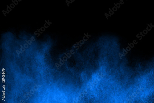 Blue powder explosion on black background. Colored cloud. Colorful dust explode. Paint Holi.