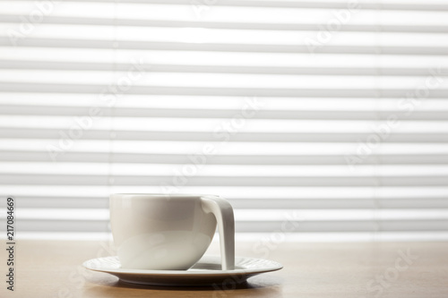 white coffee cup on the wood table at the office