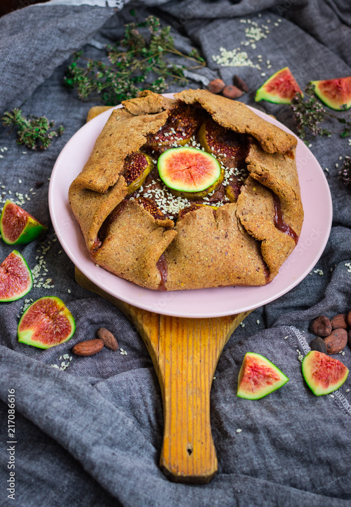 Tasty delicious lean fig tart full of sweet fruits and dry fruits. Backed in oven, made for fasting days. Sweet vegan dessert, vegetarian breakfast. Healthy food. No sugar added. Organic ingredients.