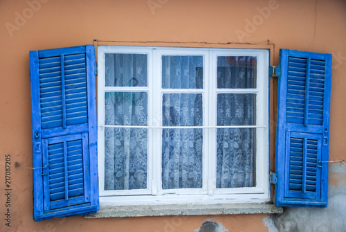house facade with wooden blue shutter