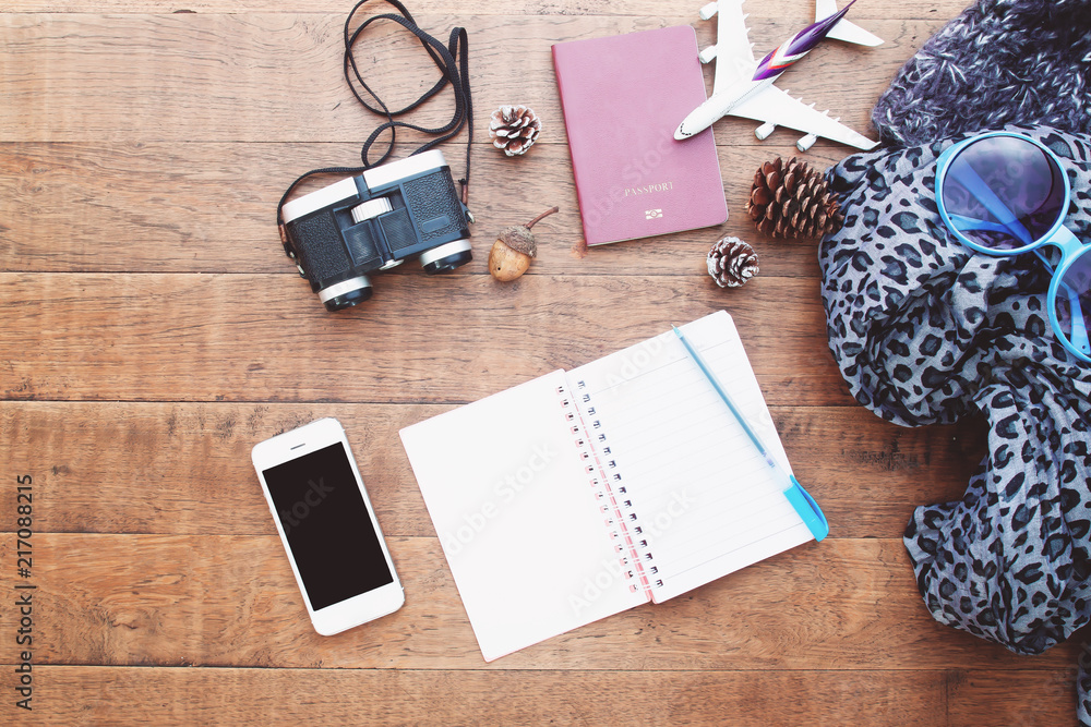 Preparation for travel, mobile phone, binoculars, passport and blank notebook for your text, Flat lay, Film filter colour style Preparation for travel, mobile phone, binoculars, passport and blank notebook for your text, Flat lay, Film filter colour style