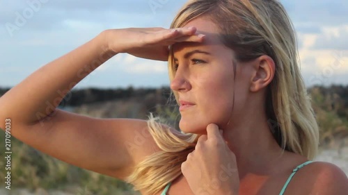 Pretty blonde woman looking at the beach 