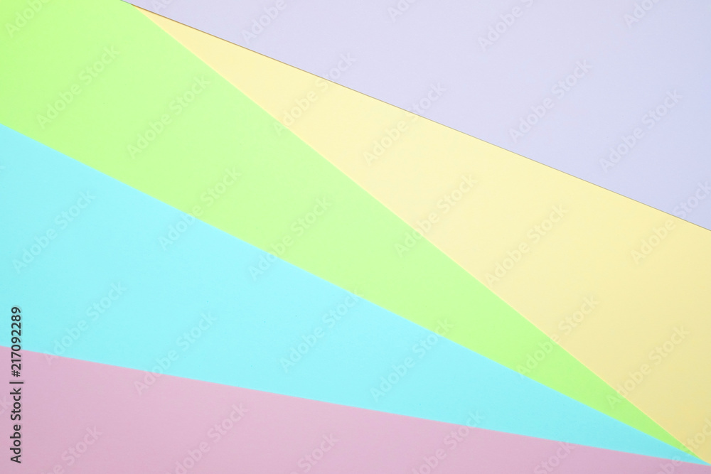 Fashionable  pastel colored paper flat lay top view, geometric background texture, pink, purple, yellow, beige, green and blue.