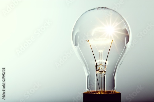 Glowing yellow light bulb, busienss idea concept photo