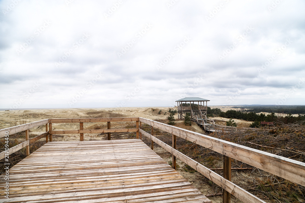 Wooden observation deck with a beautiful view of the dunes of the Curonian spit Wooden observation deck with a beautiful view of the dunes of the Curonian spit