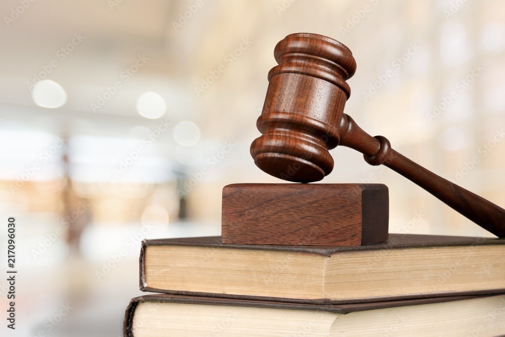 Judge hammer and documents on library background Judge hammer and documents on library background