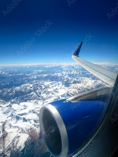 Aerial view from the airplane window, snow cover the mountains