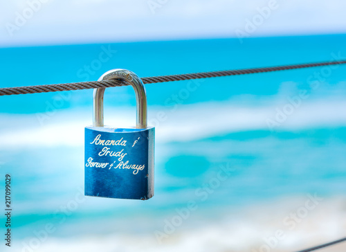 Blue padlock sign of eternal love by couples on beach and ocean view in sunny day in Gold Coast Australia
