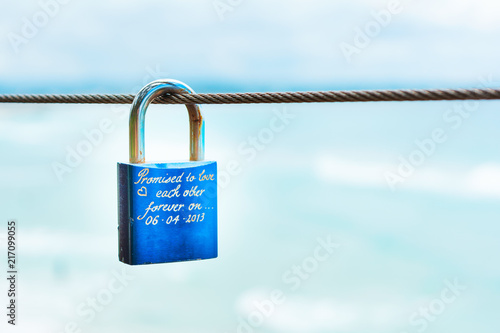 Blue padlock sign of eternal love by couples on beach and ocean background view in sunny day in Gold Coast Australia