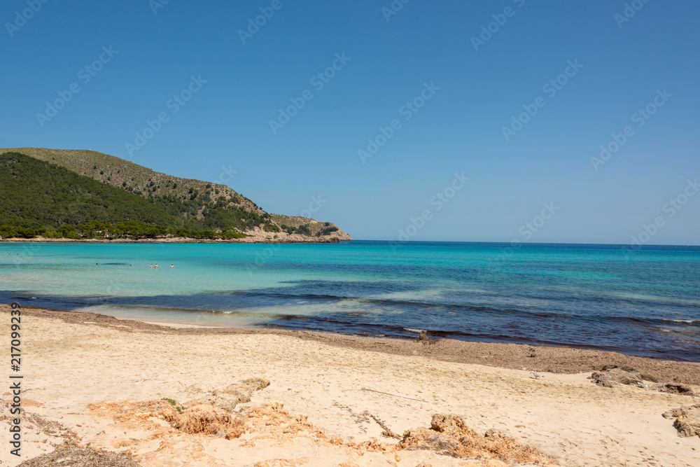 View of the turquoise Mediterranean Sea and the beautiful sandy beach of Cala Agulla on the Spanish holiday island Mallorca