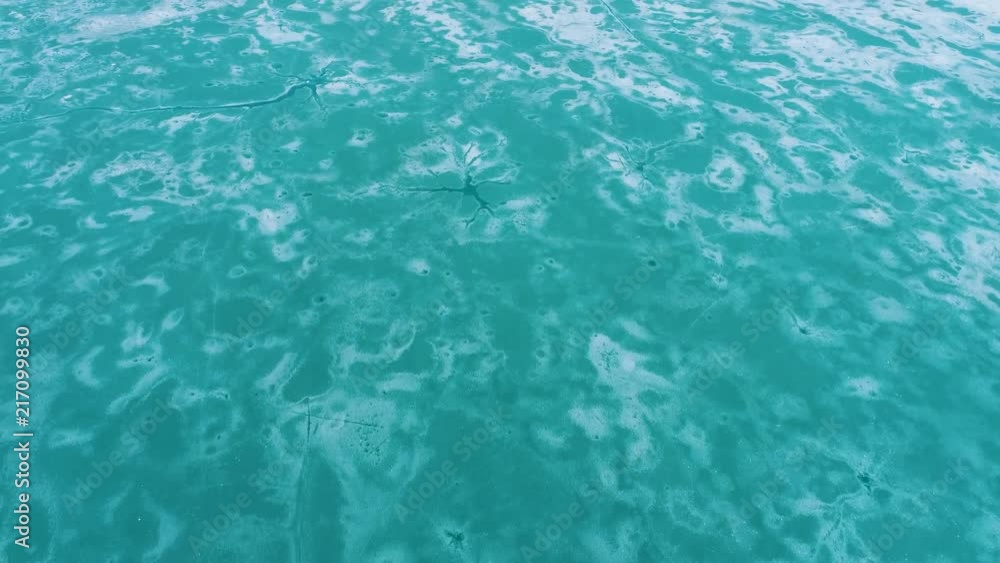 melting ice on frozen mountain lake. aerial view of cracked ice in the swiss alps engelberg melting ice on frozen mountain lake. aerial view of cracked ice in the swiss alps engelberg