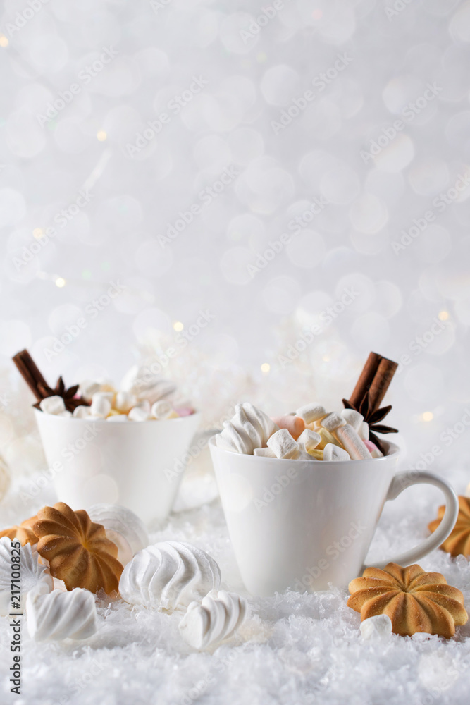 Blurred background of winter frost and Christmas chocolate spice beverage with cookies in white cups Blurred background of winter frost and Christmas chocolate spice beverage with cookies in white cups