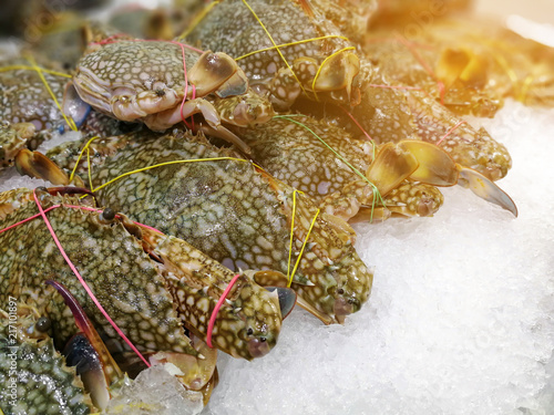 Fresh crab on ice at the seafood booth in a market for sale use for cooking